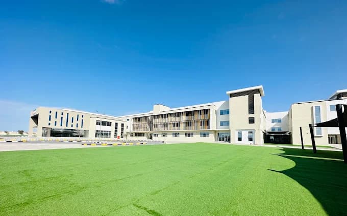 Campus sports field and school building