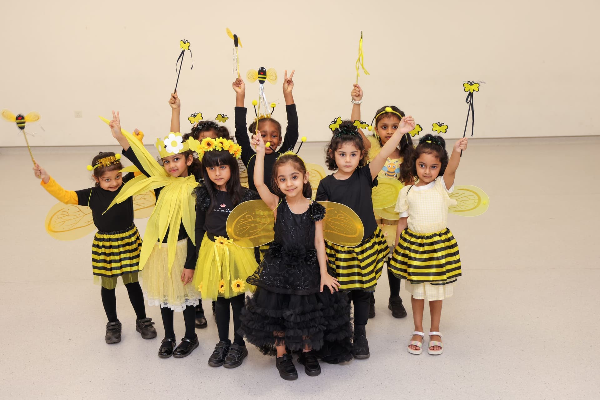 Kindergarten children performing in bee costumes