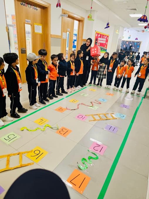Kindergarten children doing a floor learning activity in the corridor