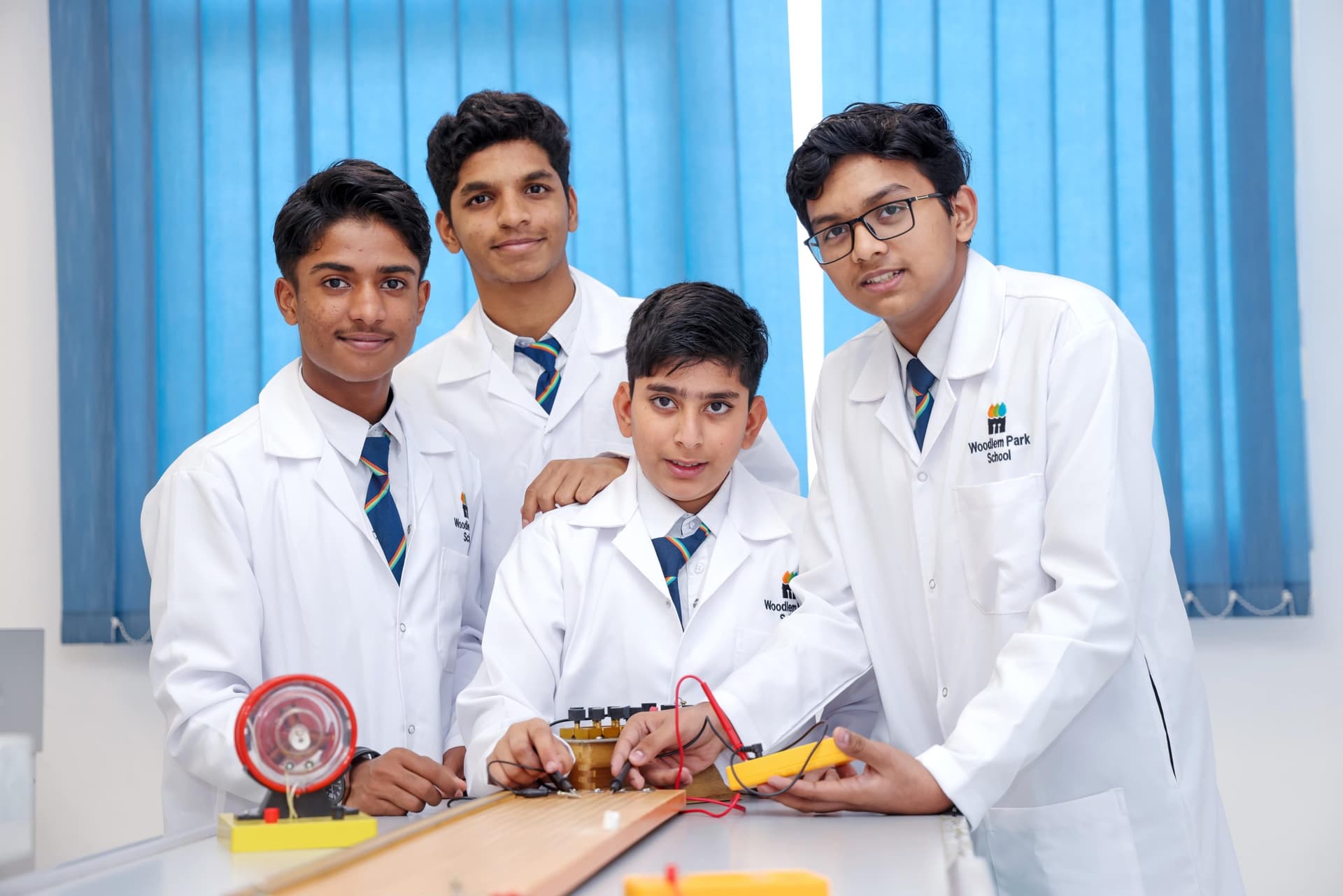 Secondary students in lab coats in the science laboratory