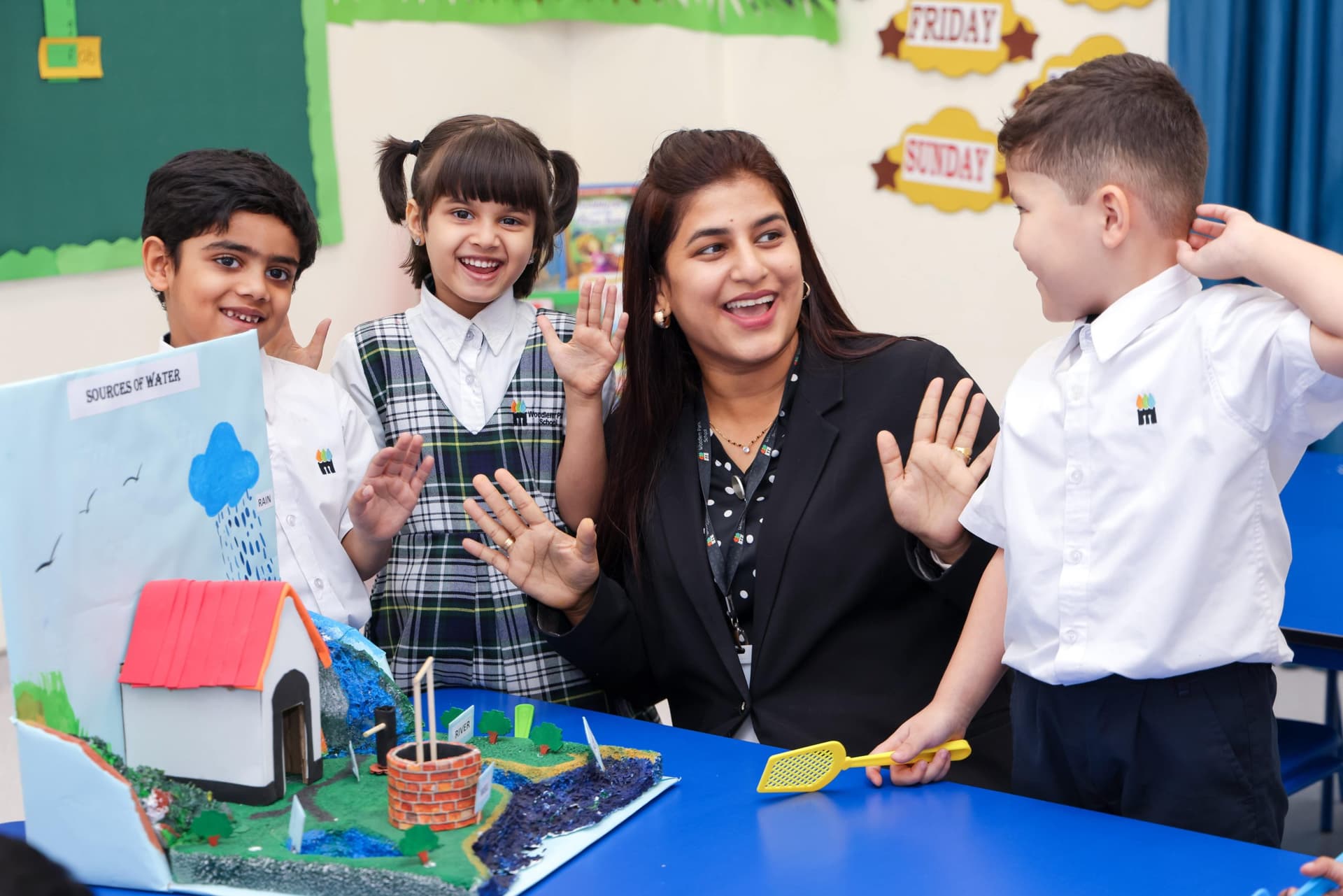 Teacher working with kindergarten children on a model